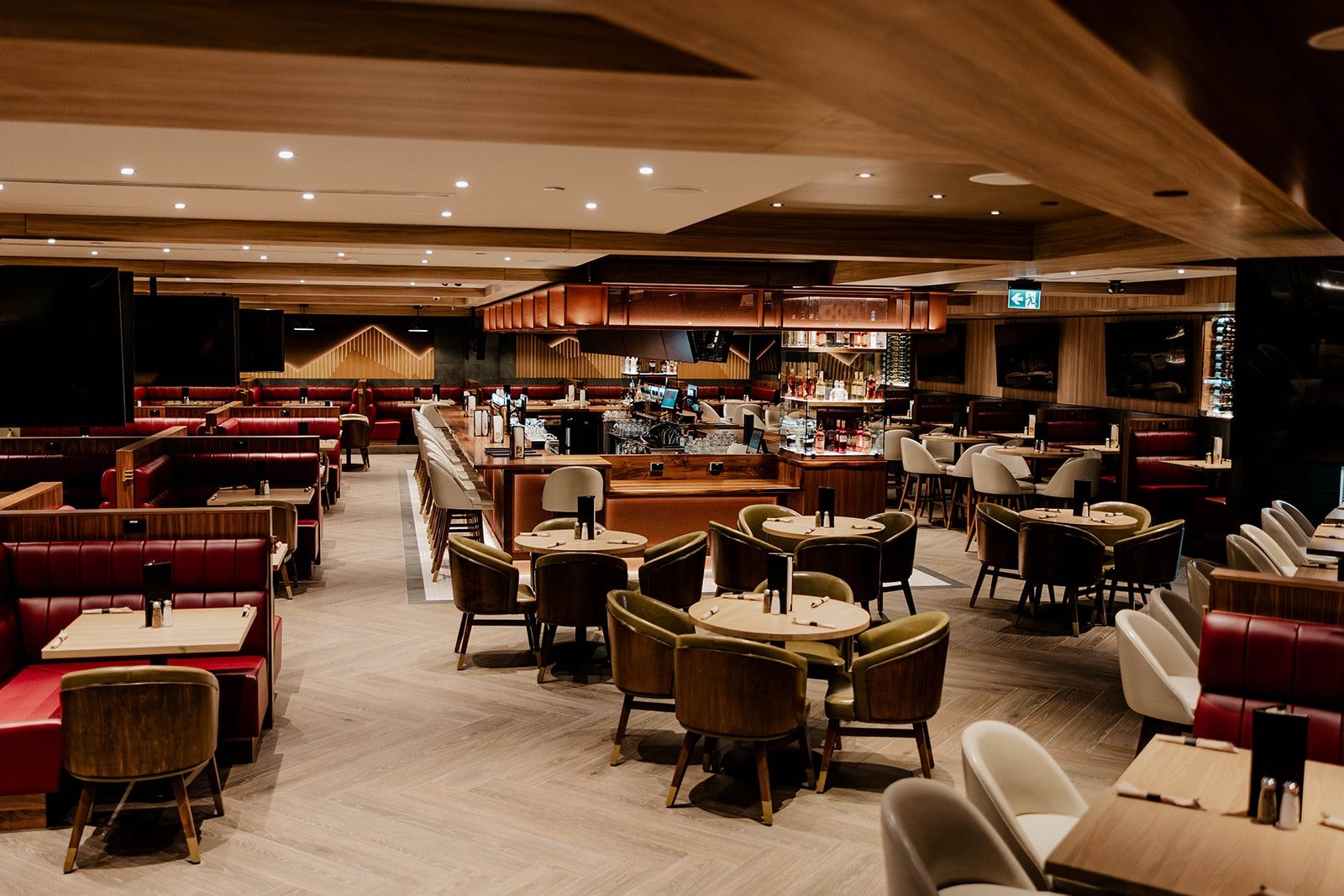 Booth and lounge seating around the central bar of an airport dining room at Vancouver International Airport